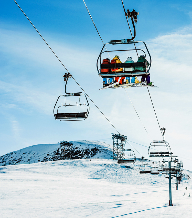 People on ski lift in winter ski resort - Holidays, snow gear renting, skiing, snowboarding and mountain landscape concept - Focus on guys sitting in cable car