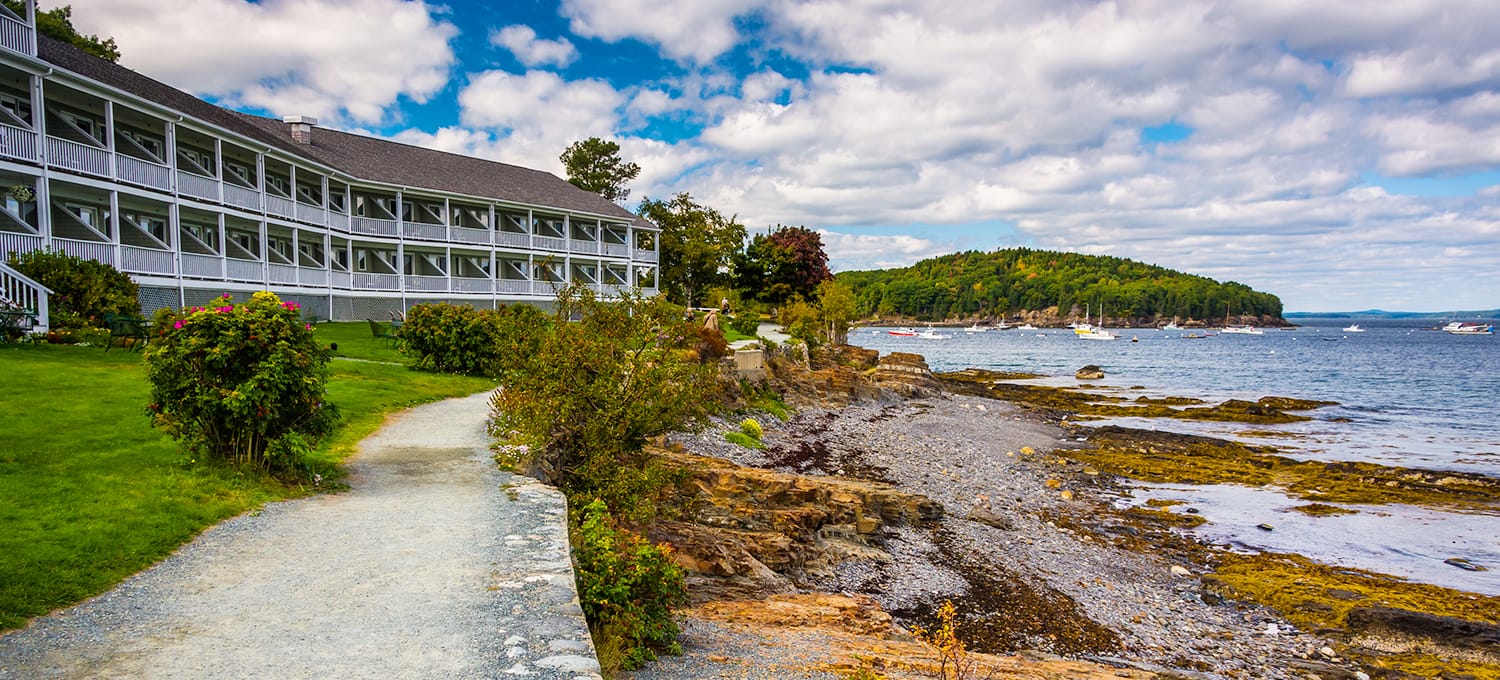 Stone path next to a hotel in Maine near the water.